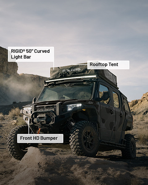 Front HD bumper, RIDIG 50-inch curved light bar, rooftop tent and Pro Armor Crawler XG Tires accessories from the Overland Package installed on a 2025 Polaris XPEDITION ADV 5 NorthStar side-by-side.