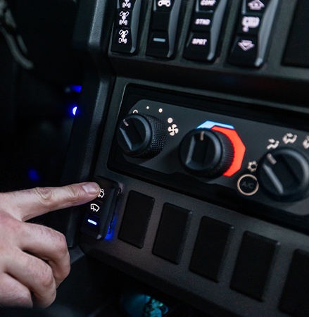 Heat and air conditioning dials inside of the enclosed cab of a 2026 Polaris XPEDITION ADV SxS.
