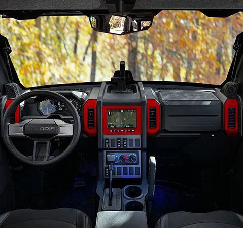 Closeup of the dash and steering column inside of the all-season cab of a 2026 Polaris XPEDITION ADV performance side-by-side.