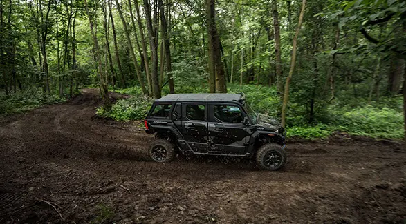 Side profile of a 2026 Polaris XPEDITION ADV 5 NorthStar performance SxS taking a tight corner with ease.