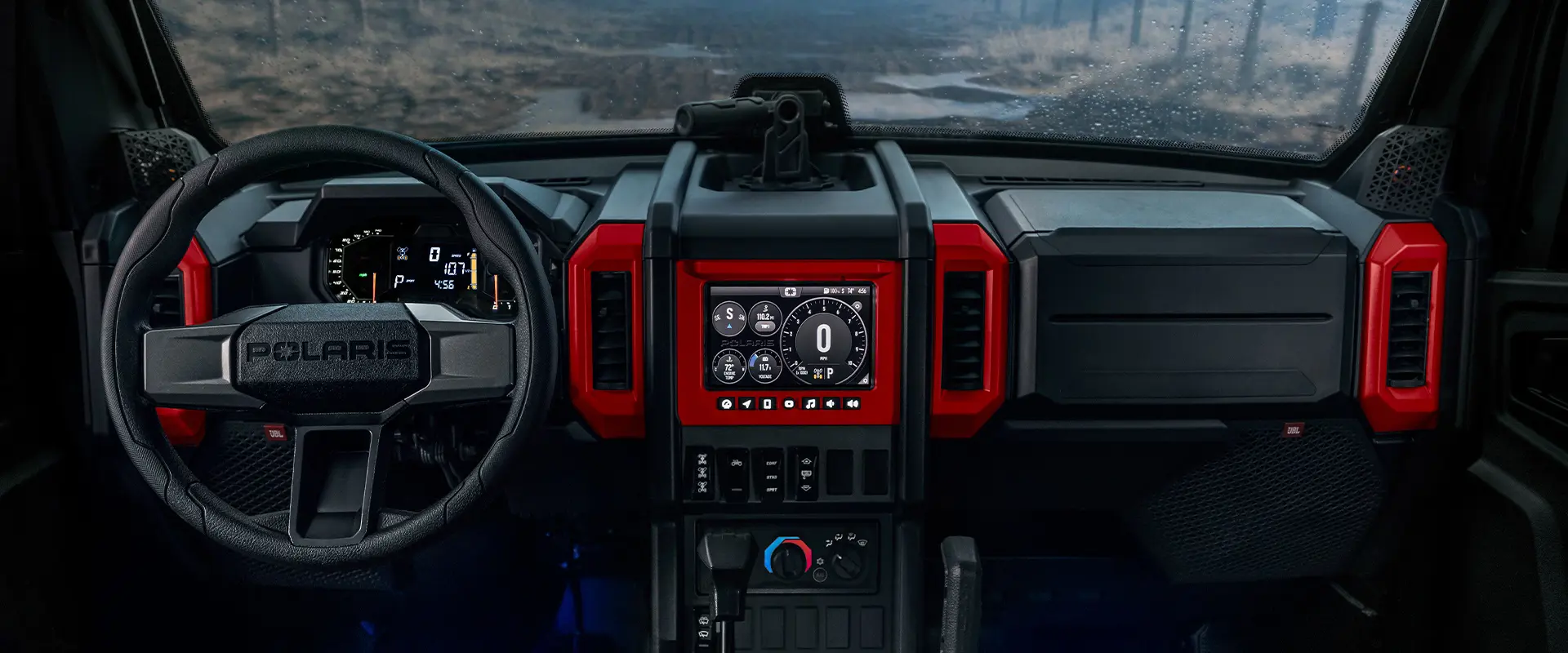 Interior view of the cab with red accents of a 2026 Polaris XPEDITION ADV NorthStar performance side-by-side.