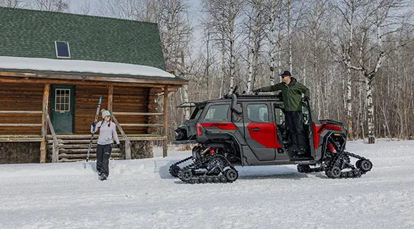 Side profile of a 2026 Polaris XPEDITION ADV NorthStar performance side-by-side with tracks installed.