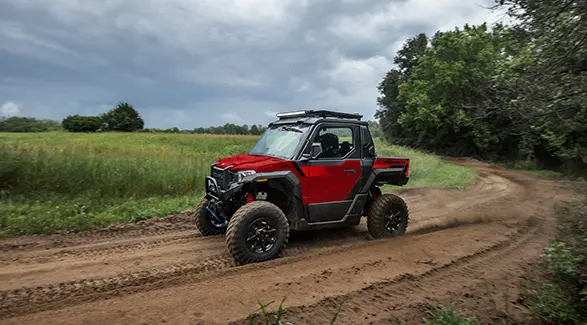 Side profile of a 2026 Polaris XPEDITION XP NorthStar side-by-side cruising on a trail.