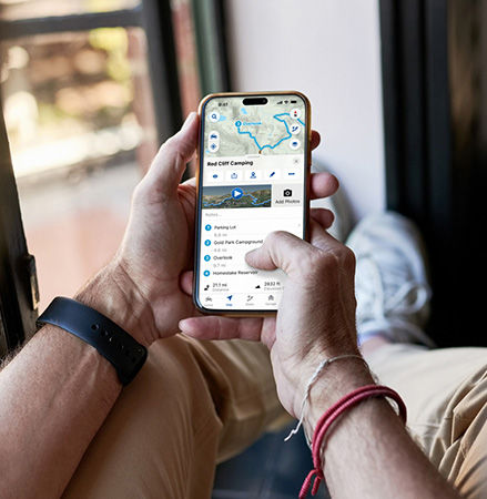 A person planning a trip using the RIDE COMMAND app.