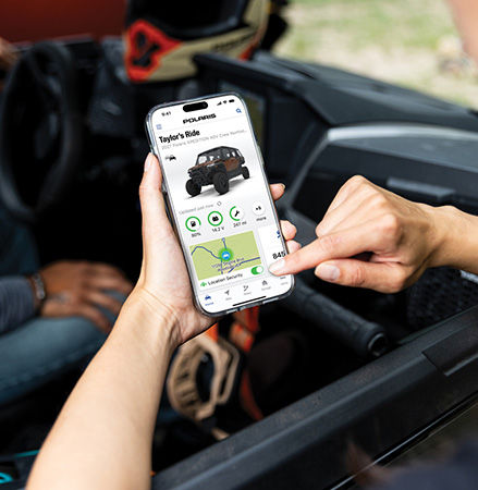A person using the RIDE COMMAND+ app for their Polaris XPEDITION performance SxS.