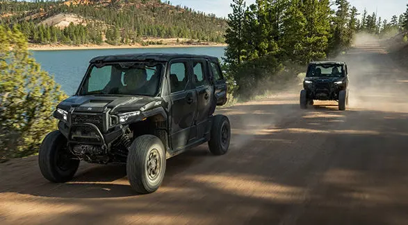 Two 2027 Polaris XPEDITION ADV NorthStar side-by-sides driving down a trail.