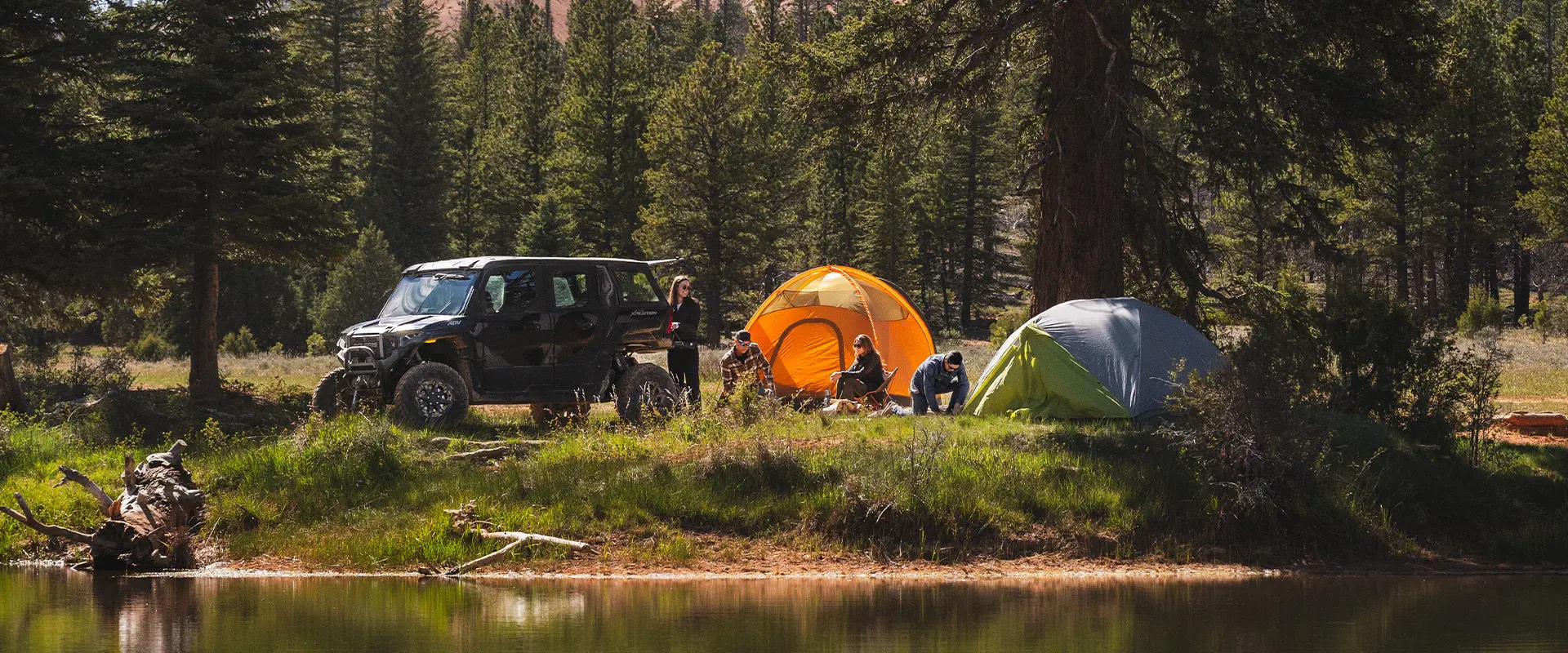 A person unloading gear from a 2027 Polaris XPEDITION ADV 5 NorthStar side-by-side.