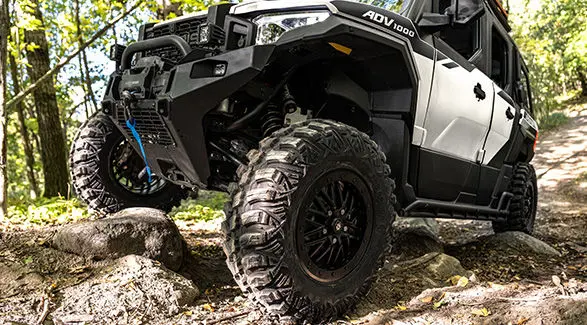 Closeup of the tires and shocks of a 2027 Polaris XPEDITION ADV 5 NorthStar side-by-side.