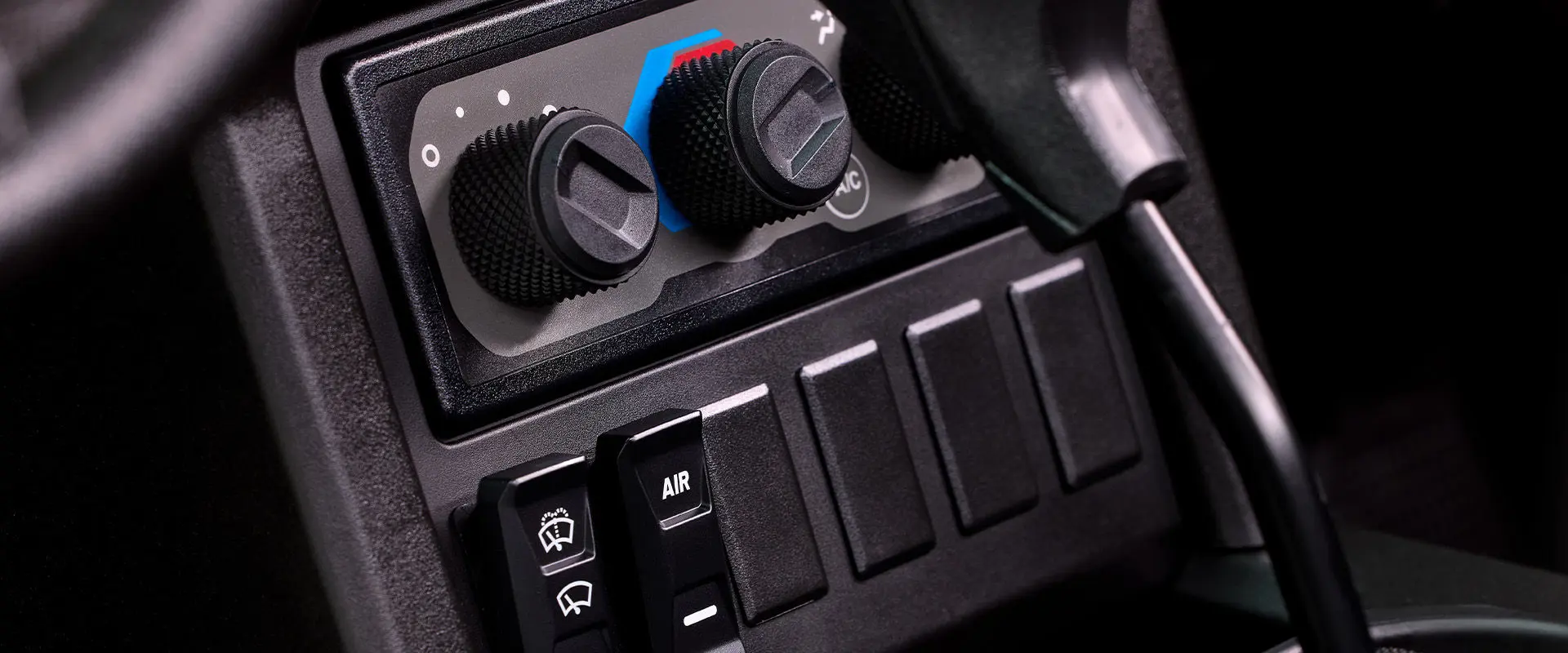 Thermostat controls and other buttons in the cab of a 2027 Polaris XPEDITION ADV NorthStar side-by-side.