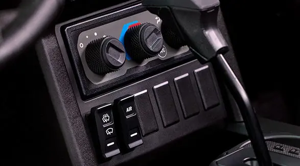 Thermostat controls and other buttons in the cab of a 2027 Polaris XPEDITION ADV NorthStar side-by-side.
