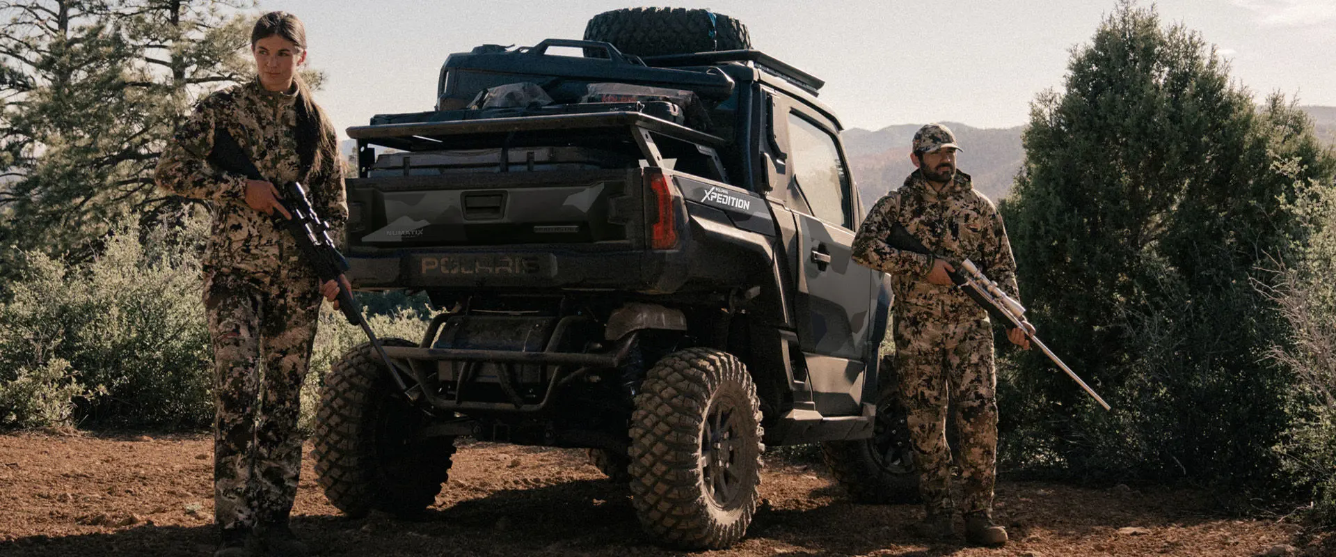 2 hunters walking away from a 2027 Polaris XPEDITION XP NorthStar side-by-side.