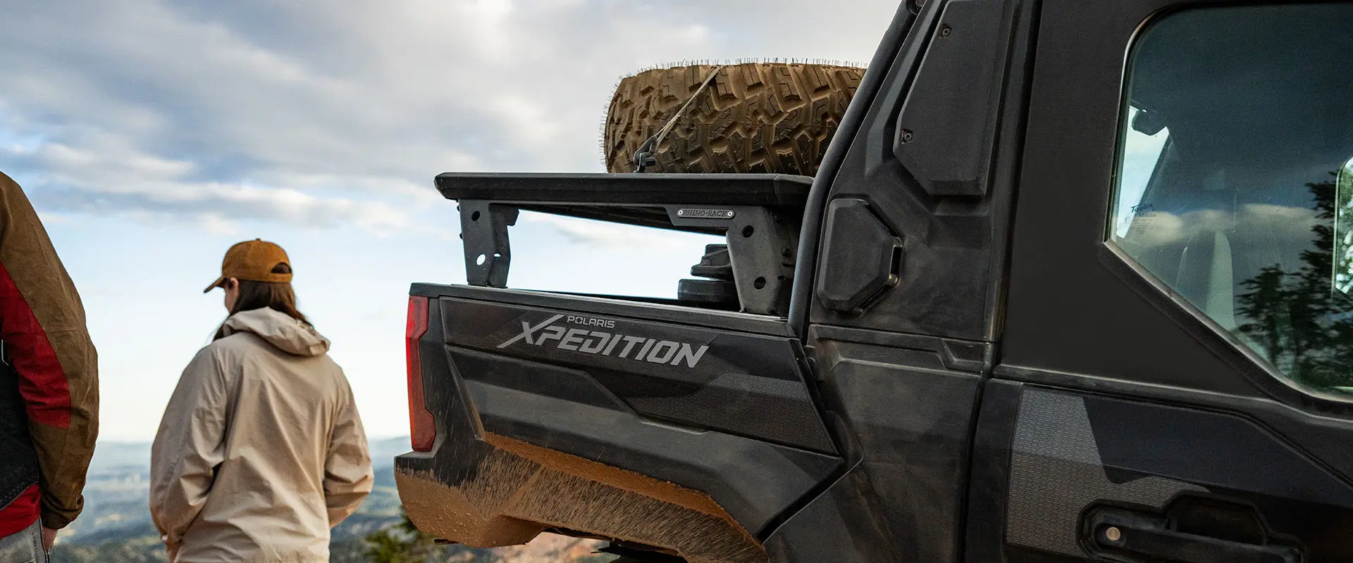 2 people overlooking the landscape near their 2027 Polaris XPEDITION XP NorthStar side-by-side.
