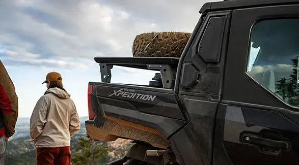 2 people overlooking the landscape near their 2027 Polaris XPEDITION XP NorthStar side-by-side.